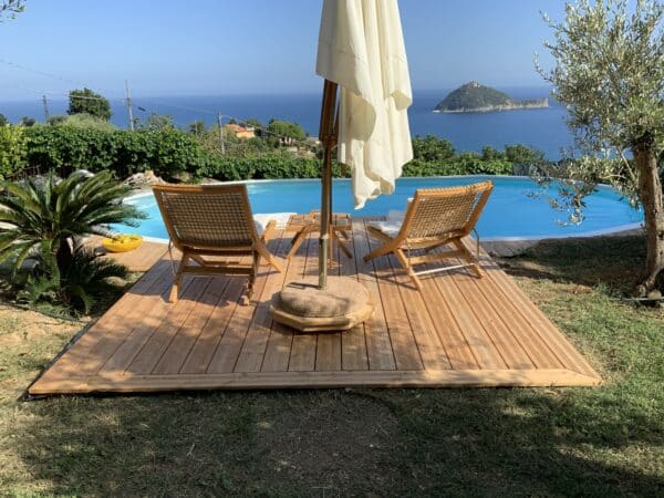 Poolgestaltung, versenktes Pool im Hintergrund das Meer, Holzsteg mit zwei Liegen, Sommer, Schwimmbad, Cranpool, Traum Pool